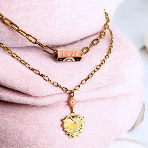 Gold toned chains with black, white, gold, and pastel pink enamel charms. - Picture 8 of 17